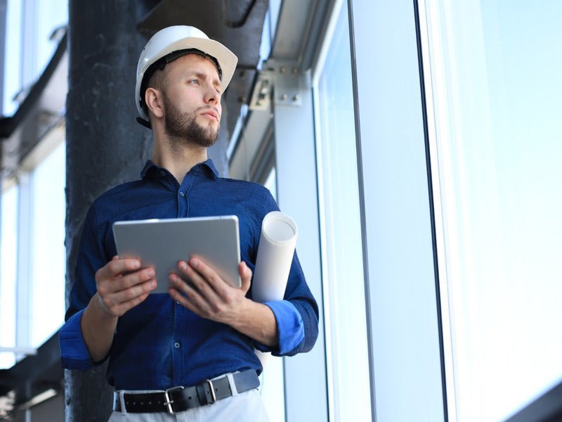 Engineer with tablet inside a commercial building