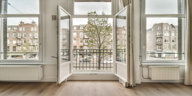 Wide-open windows airing out a room