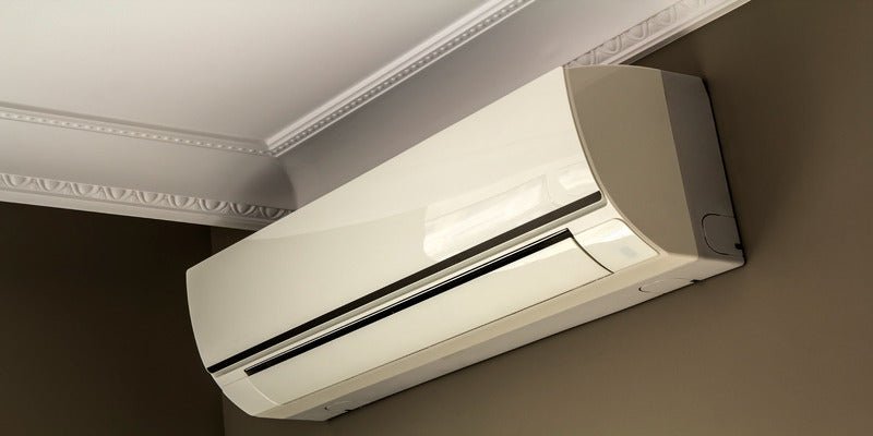 Split AC mounted below ceiling molding