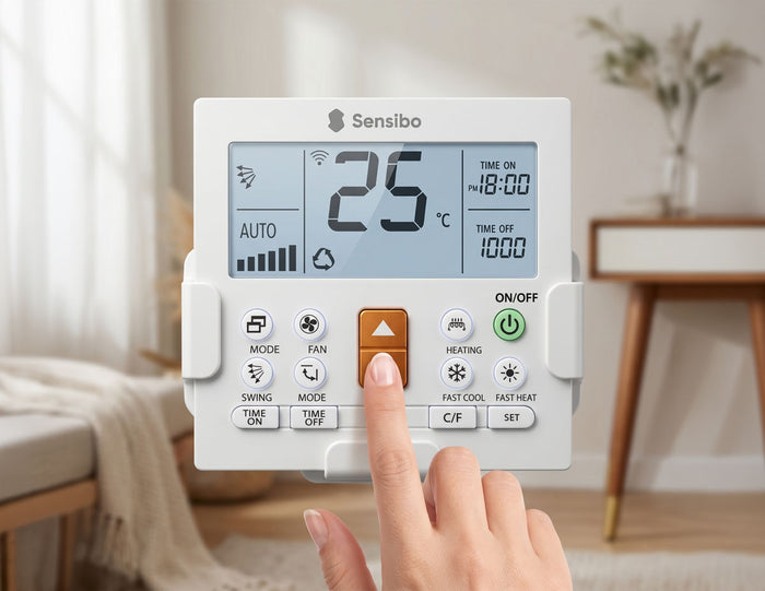 Sensibo smart remote mounted on the wall next to a split AC